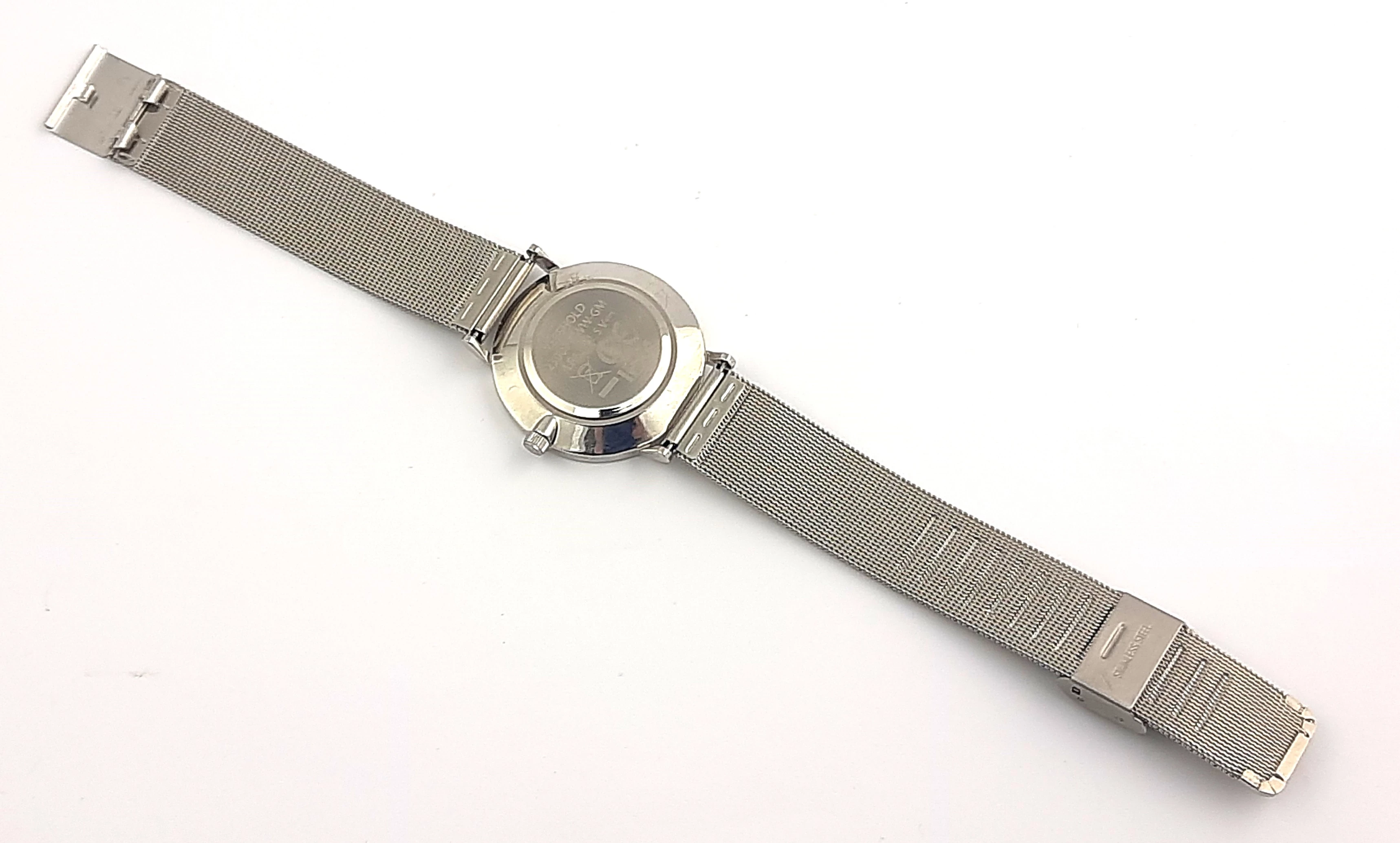 zegarek-damski-thierry-schaeffer-na-srebrnej-bransolecie-ksztalt-koperty-okragla